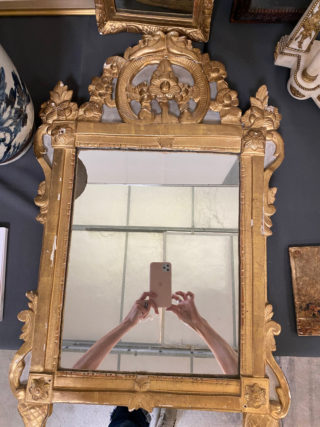 Carved gold rectangular mirror with ornate top carving