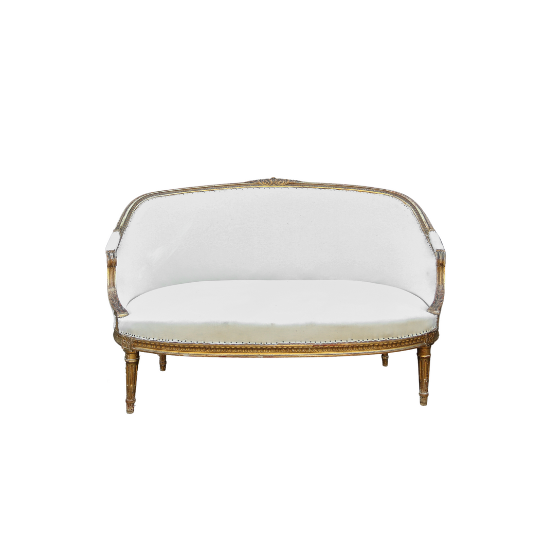 Curved settee with gold paint covered in white fabric