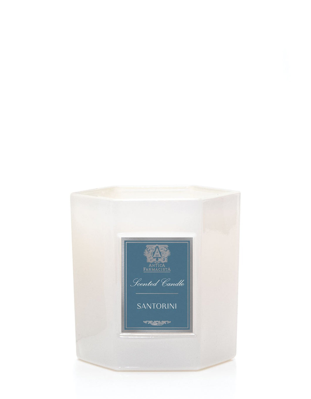 Hexagonal soft white glass candle with blue Antica Farmacista label